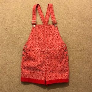 Red overalls with a white paisley pattern. (BDG)